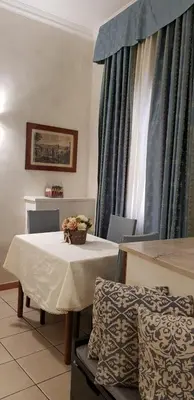 a table with a bowl of flowers on top of it at Apartment Julia Guesthouse Trevi - Spagna in Rome