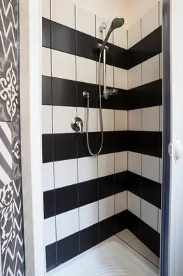 a black and white tile bathroom with a shower at I Love Piramide in Rome