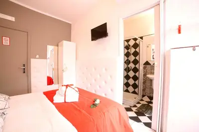 a bedroom with a bed with a red blanket and a mirror at I Love Piramide in Rome