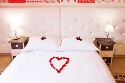 a bedroom with a heart on the bed at I Love Piramide in Rome