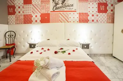 a bedroom with a large bed with flowers on it at I Love Piramide in Rome