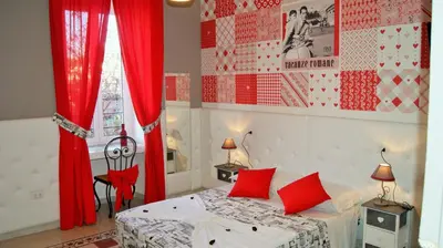 a bedroom with a bed with red drapes at I Love Piramide in Rome