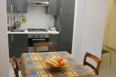 a kitchen with a table with a bowl of fruit on it at Vatican Apartment in Rome