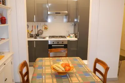 a kitchen with a table with a bowl of fruit on it at Vatican Apartment in Rome