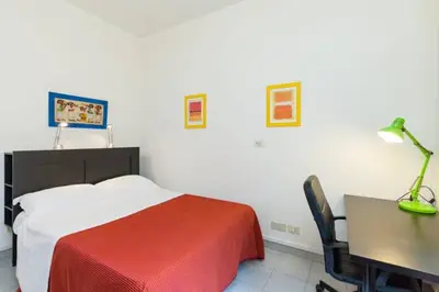a bedroom with a bed and a desk and a desk at Vatican Apartment in Rome