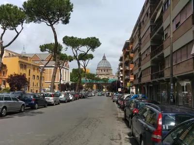 a street with cars parked on the side of the road at Rampa Brancaleone Apartment in Rome