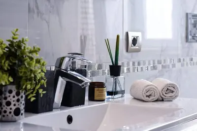 a bathroom sink with towels and a faucet at Rampa Brancaleone Apartment in Rome