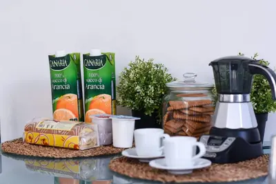 a table with a blender and some breakfast food at Rampa Brancaleone Apartment in Rome