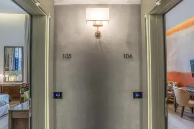 a room with a wall with two clocks on it at Hotel Martis Palace in Rome