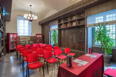 a room with red chairs and tables in a restaurant at Hotel Martis Palace in Rome