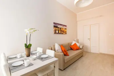 a living room with a couch and a table at G-House Pettinari in Rome