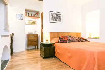 a bedroom with a bed and a wooden floor at Navona Stay Apartment in Rome