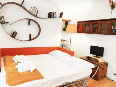 a bedroom with a bed with a mirror on the wall at Navona Stay Apartment in Rome