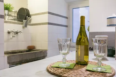 a bottle of wine and two glasses on a counter at Navona Stay Apartment in Rome