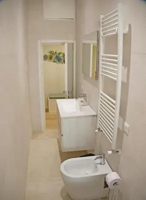 a white bathroom with a sink and a toilet at L'Esquilina Holiday House 2 in Rome