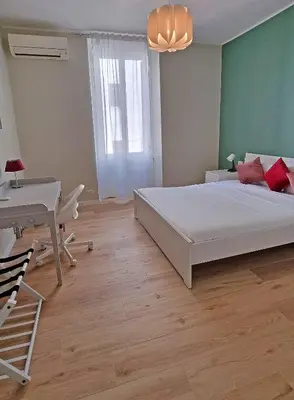 a bedroom with a bed and a desk and a table at L'Esquilina Holiday House 2 in Rome