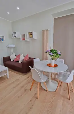 a living room with a white table and a couch at L'Esquilina Holiday House 2 in Rome