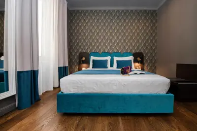 a bedroom with a blue bed with a blue head board at Hotel 87 eighty-seven - Maison d'Art Collection in Rome