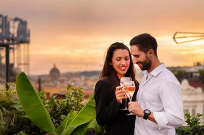 a man and a woman holding a glass of wine at Hotel 87 eighty-seven - Maison d'Art Collection in Rome