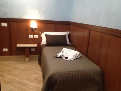 a hotel room with a bed with a white bag on it at Residenza Matteucci in Rome