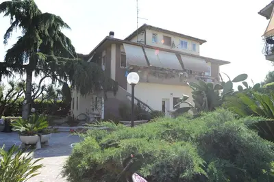 a house with a lot of plants in front of it at Casa Santarelli in Rome
