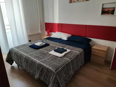 a bedroom with a bed with two towels on it at Turati House in Rome