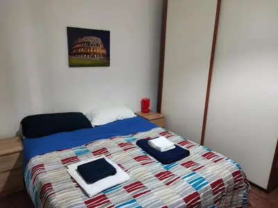 a bedroom with a bed with towels on it at Turati House in Rome