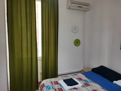 a bedroom with a bed and a green curtain at Turati House in Rome