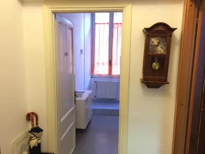 a hallway with a grandfather clock and a sink at Turati House in Rome