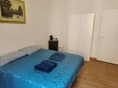 a bedroom with a blue bed with towels on it at Turati House in Rome