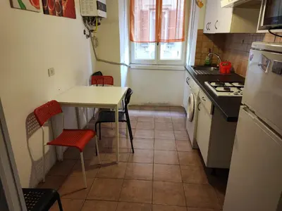 a kitchen with a table and a table and chairs at Turati House in Rome
