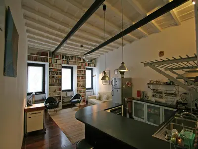 a room with a kitchen and a living room at Casa Leopardo - Trastevere in Rome