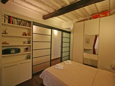 a bedroom with a bed and a book shelf at Casa Leopardo - Trastevere in Rome