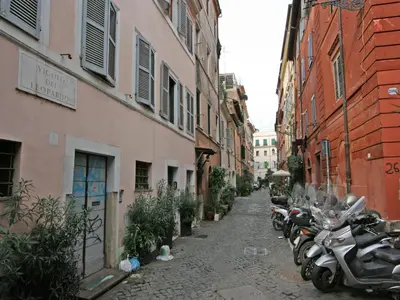 a narrow alley with motorcycles parked next to buildings at Casa Leopardo - Trastevere in Rome