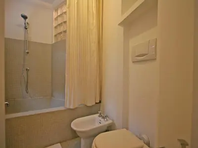 a bathroom with a toilet and a shower and a sink at Casa Leopardo - Trastevere in Rome