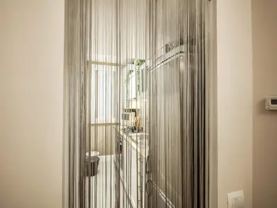 a shower curtain in a room with a window at Residenza Paola - 2BR Trastevere in Rome