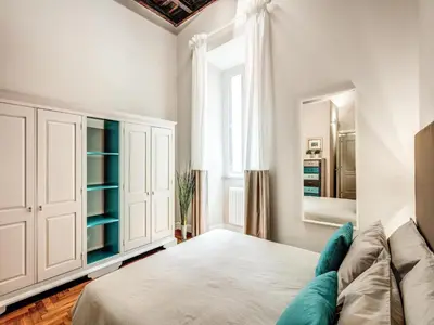 a bedroom with a bed and a mirror at Residenza Paola - 2BR Trastevere in Rome