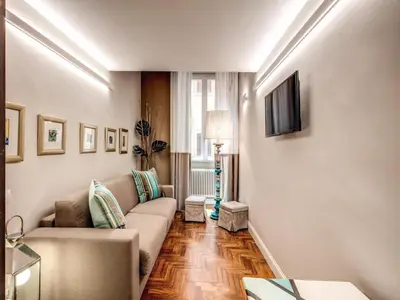 a living room with a couch and a television at Residenza Paola - 2BR Trastevere in Rome