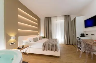a bedroom with a bed and a bathroom with a tub at Vatican Style in Rome