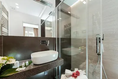 a bathroom with a sink and a glass shower at Vatican Style in Rome