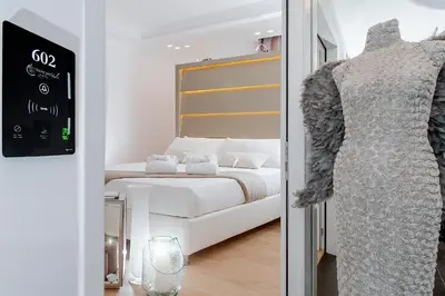 a bedroom with a bed and a dress on a mannequin at Vatican Style in Rome