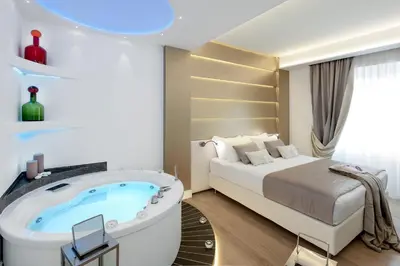 a hotel room with a bed and a tub at Vatican Style in Rome