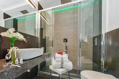 a bathroom with a sink and a glass shower at Vatican Style in Rome