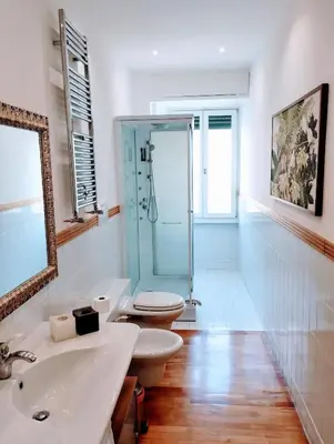 a bathroom with a shower and a toilet and a sink at Eluta Holiday Home in Rome