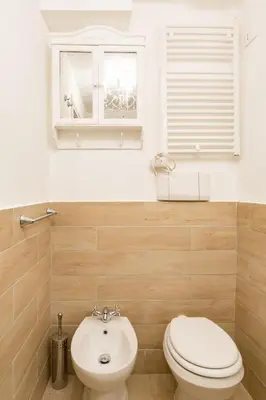 a bathroom with a toilet and a sink and a window at La Maison de la vie in Rome