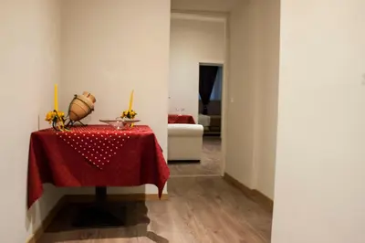 a table with a red table cloth and candles on it at Holiday House Roma Vaticano in Rome