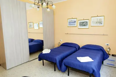 a room with blue cushioned chairs in front of a mirror at Casa Vacanza Da Andrea in Rome