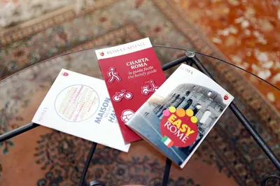 a glass table with two pamphlets on top of it at Casa Vacanza Da Andrea in Rome
