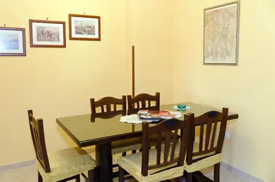 a dining room with a wooden table and chairs at Casa Vacanza Da Andrea in Rome