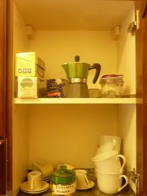 a kitchen shelf with various kitchen items on it at Casa Vacanza Da Andrea in Rome